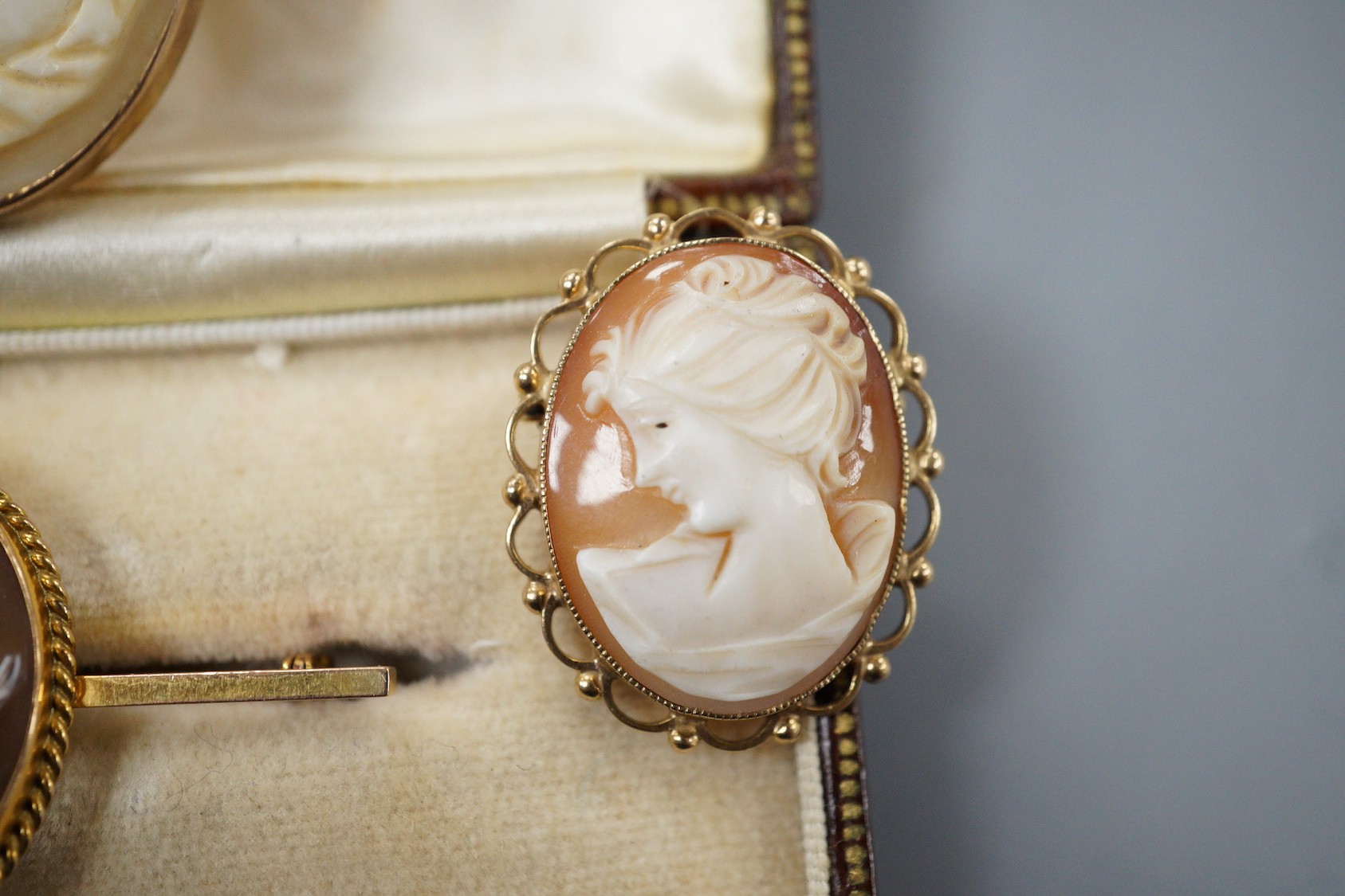 Two modern 9ct gold mounted oval cameo shell brooches, largest 30mm, a 9ct and oval cameo shell set bar brooch and one other yellow metal mounted cameo brooch(lacking pin).